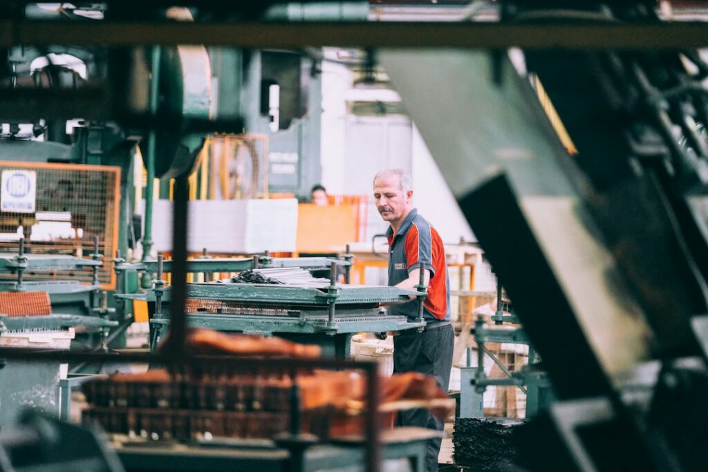 Factory worker operating industrial machinery in a manufacturing facility